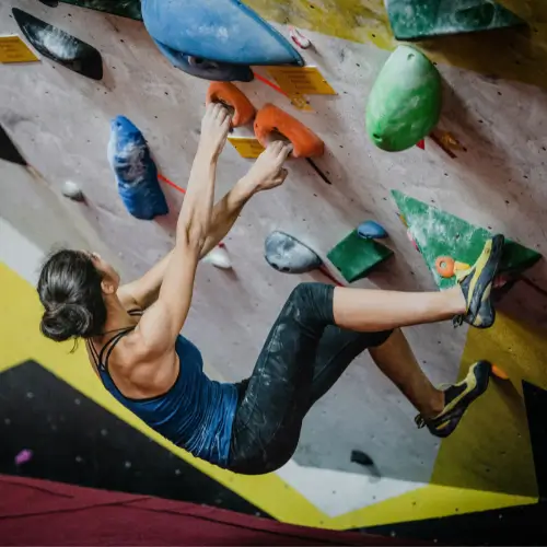 Climber bouldering indoors